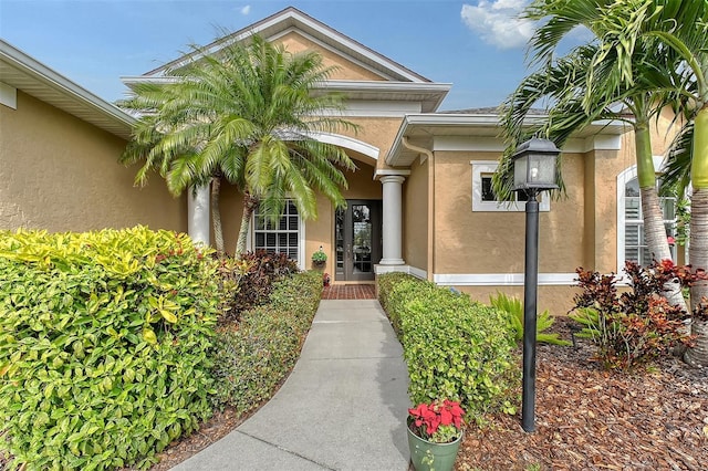 entrance to property featuring stucco siding