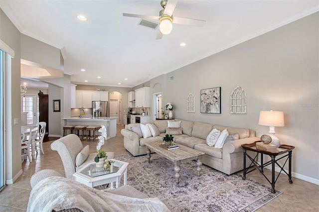 living room featuring light tile patterned floors, recessed lighting, visible vents, ornamental molding, and baseboards