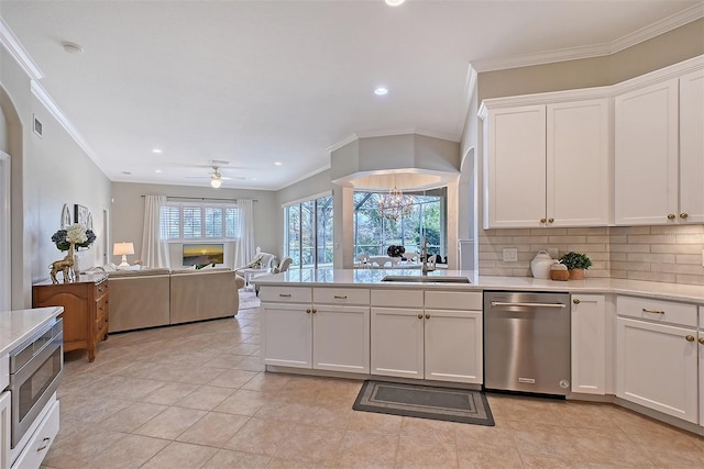 kitchen with a sink, white cabinetry, light countertops, and dishwasher