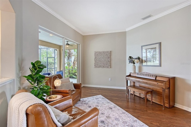 sitting room with crown molding, visible vents, dark wood-type flooring, ceiling fan, and baseboards