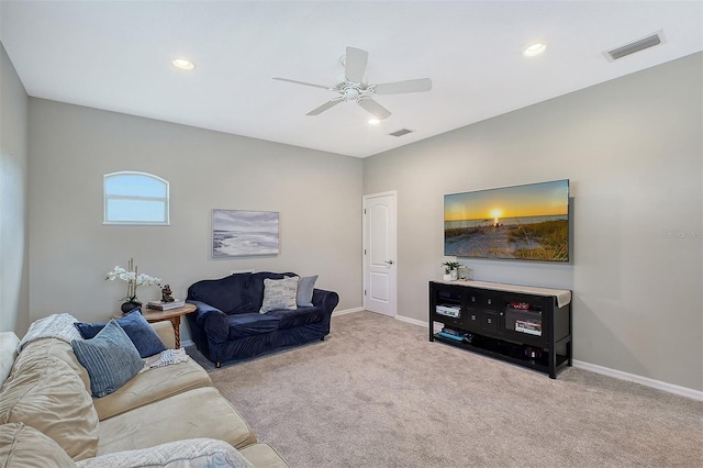 living room with light carpet, visible vents, and baseboards