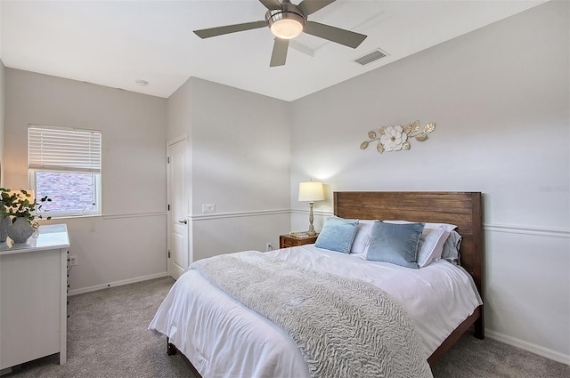 carpeted bedroom featuring ceiling fan, visible vents, and baseboards