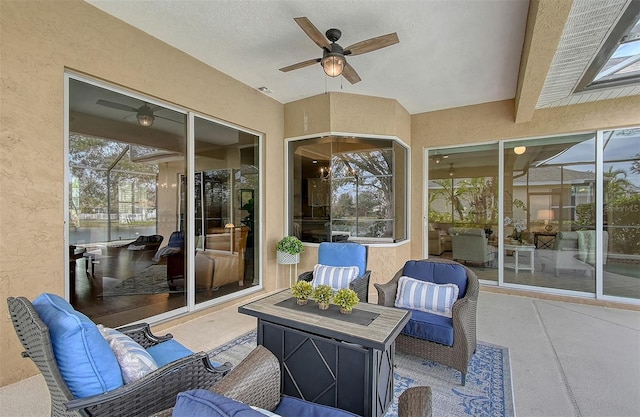 view of patio / terrace with glass enclosure, ceiling fan, and outdoor lounge area