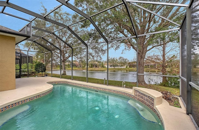 outdoor pool with a patio area, glass enclosure, and a water view