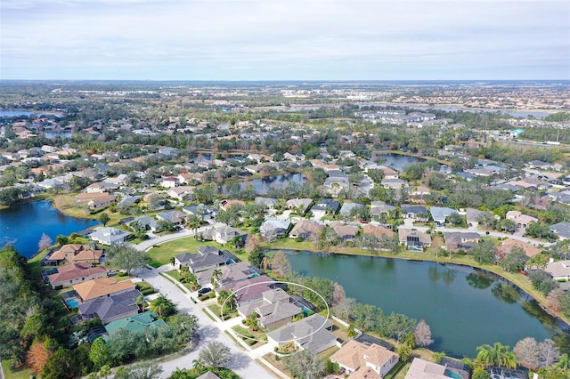 drone / aerial view with a residential view and a water view