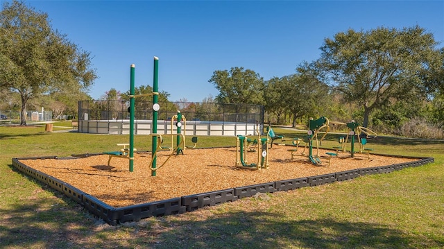 communal playground with fence and a yard