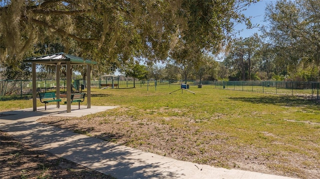 view of property's community with a yard and fence