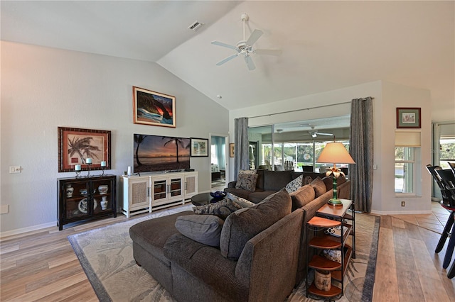 living room featuring light wood-type flooring, plenty of natural light, and ceiling fan