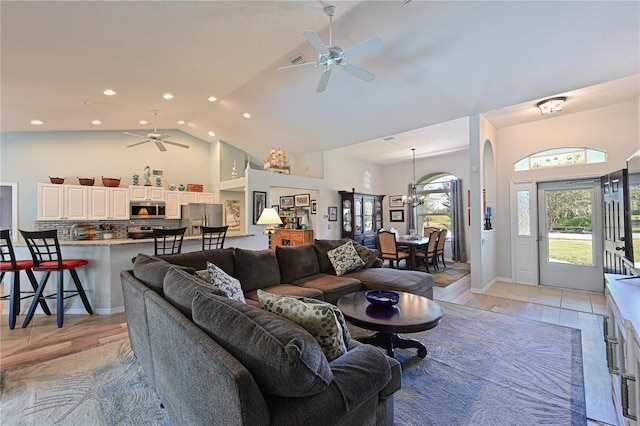 living room featuring light wood-type flooring, high vaulted ceiling, and ceiling fan