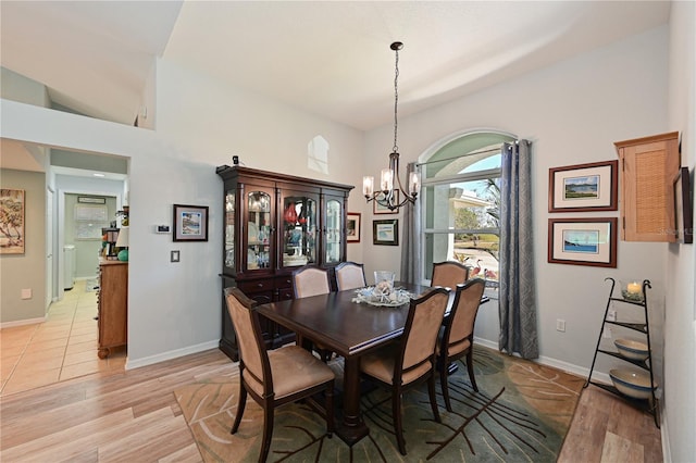 dining area featuring light hardwood / wood-style floors and an inviting chandelier