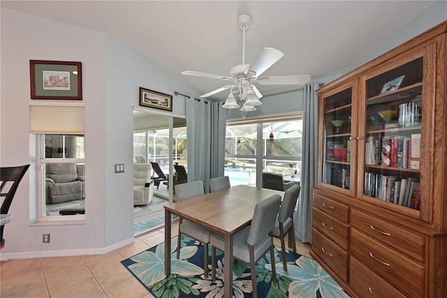 tiled dining room featuring ceiling fan and lofted ceiling