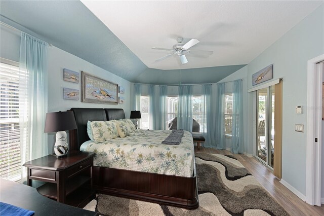 bedroom featuring access to exterior, ceiling fan, light hardwood / wood-style flooring, and lofted ceiling