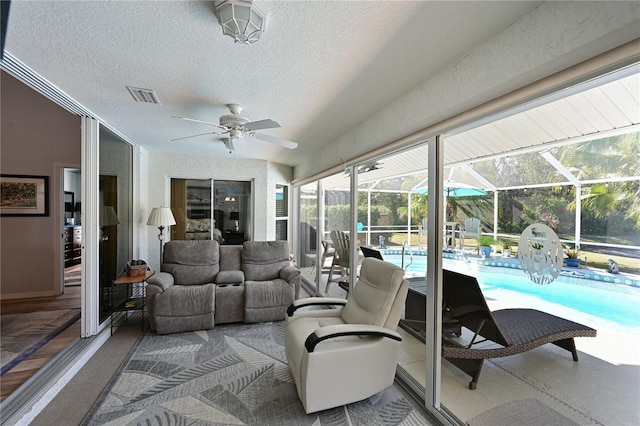 interior space with ceiling fan and a pool