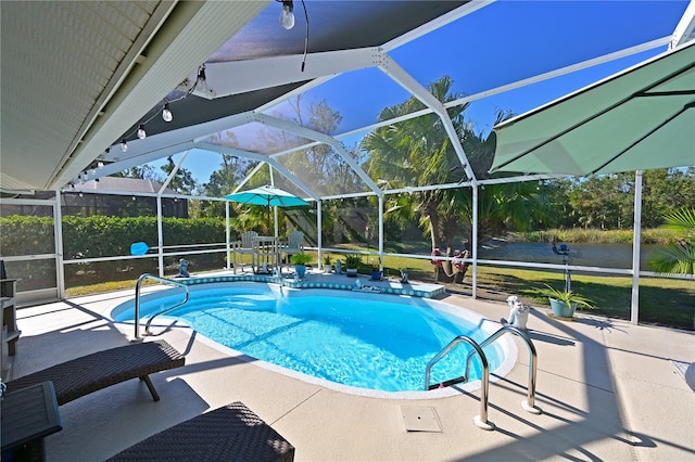 view of pool with glass enclosure and a patio