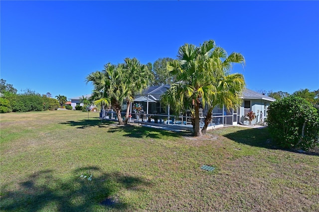 view of yard featuring a lanai and a swimming pool