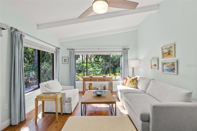 living room with vaulted ceiling with beams, hardwood / wood-style flooring, and ceiling fan