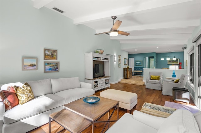 living room featuring beamed ceiling, ceiling fan, and dark hardwood / wood-style flooring