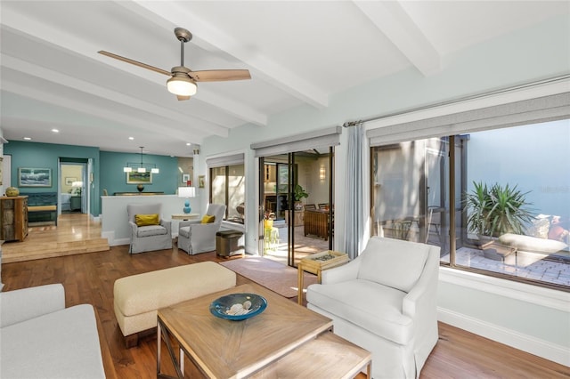 living room with hardwood / wood-style floors, lofted ceiling with beams, and ceiling fan with notable chandelier