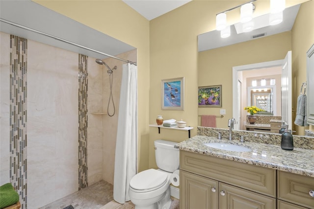 bathroom with a shower with curtain, vanity, and toilet