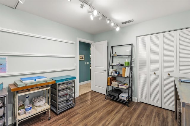 misc room featuring dark hardwood / wood-style flooring and track lighting