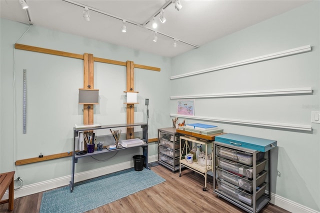 miscellaneous room featuring wood-type flooring and rail lighting