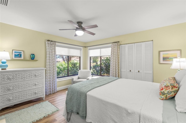 bedroom with ceiling fan and light hardwood / wood-style floors