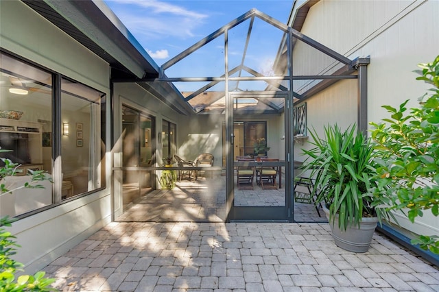 view of patio with glass enclosure