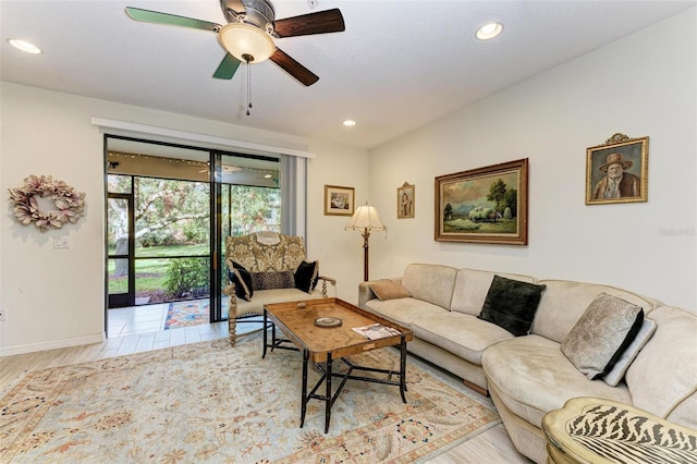 living room featuring ceiling fan and light hardwood / wood-style flooring