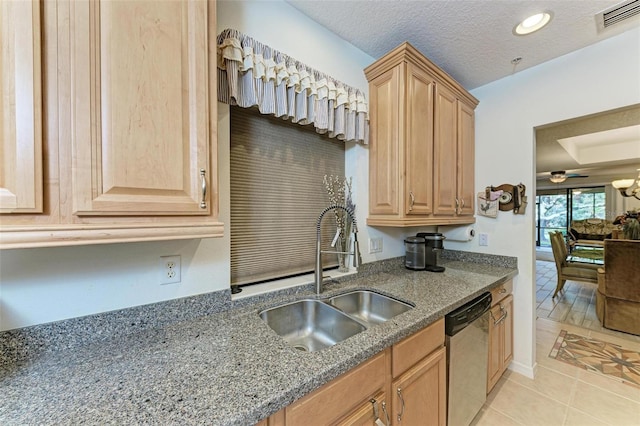 kitchen with a textured ceiling, dishwasher, light tile patterned floors, and sink