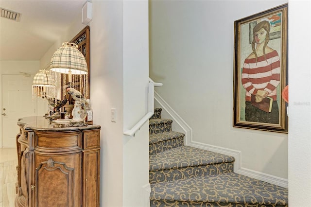 stairway with tile patterned flooring