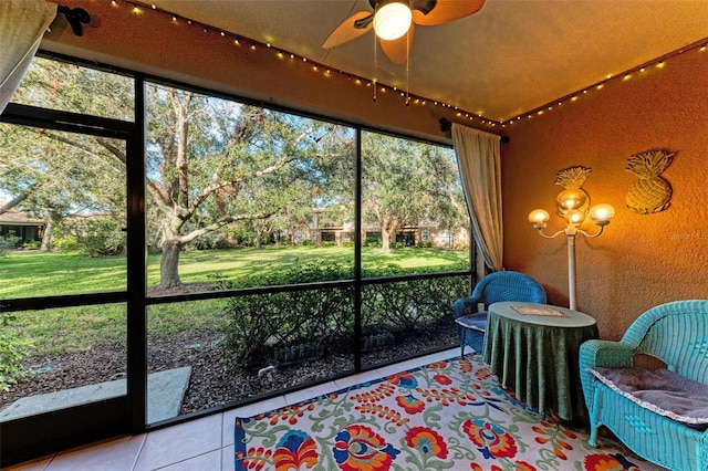 unfurnished sunroom with ceiling fan