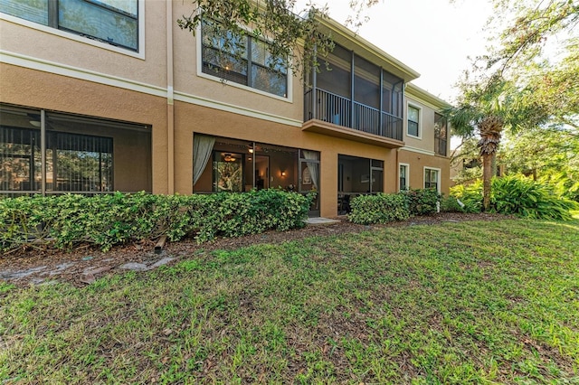 rear view of house featuring a yard