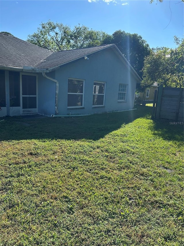 view of side of home featuring a yard