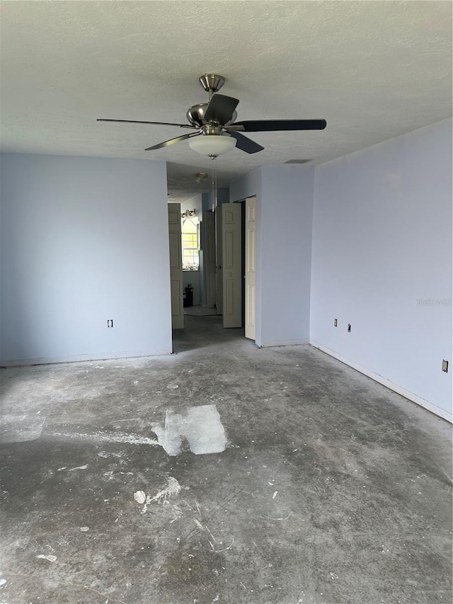 spare room featuring ceiling fan and a textured ceiling