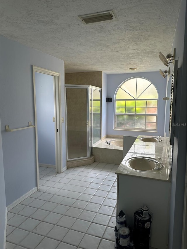 bathroom featuring vanity, plus walk in shower, and tile patterned flooring