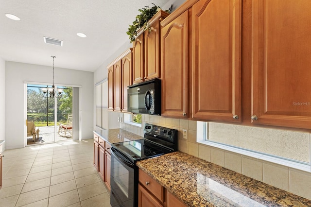 kitchen featuring pendant lighting, black appliances, decorative backsplash, dark stone countertops, and a chandelier