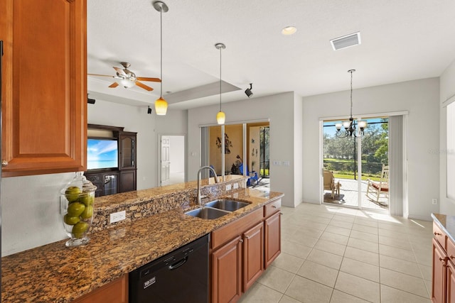 kitchen featuring ceiling fan with notable chandelier, sink, decorative light fixtures, dark stone countertops, and black dishwasher