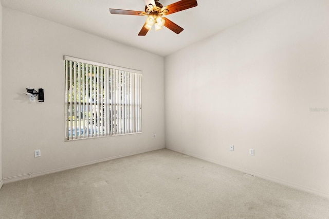 empty room with ceiling fan and light colored carpet