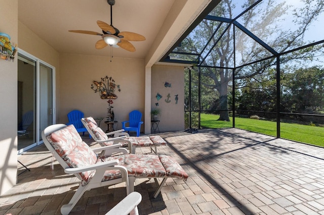 view of patio with glass enclosure and ceiling fan