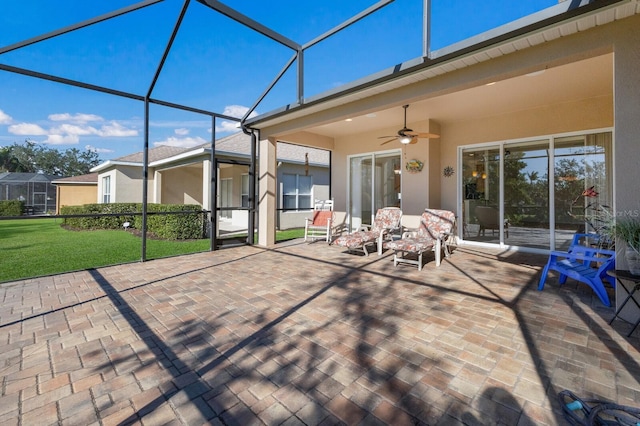 unfurnished sunroom featuring ceiling fan