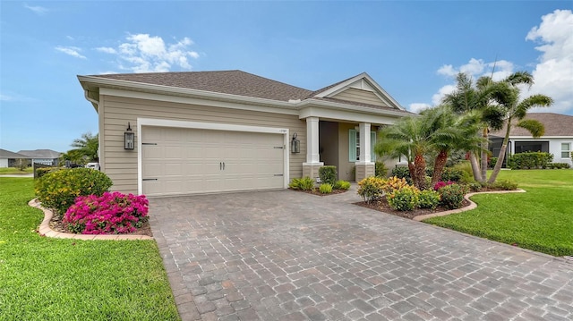 view of front of house with a garage and a front lawn