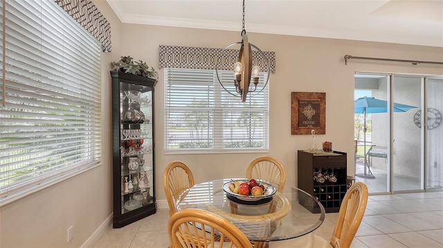 tiled dining room featuring a chandelier and ornamental molding