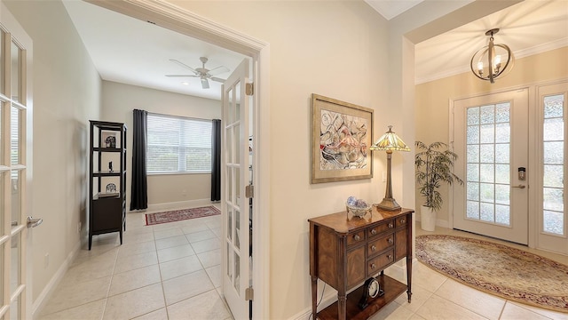 entryway featuring french doors, light tile patterned floors, and ceiling fan with notable chandelier