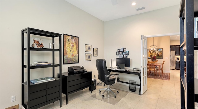 office with light tile patterned floors and a chandelier