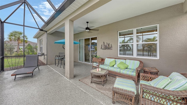 view of patio with an outdoor living space, ceiling fan, and a lanai