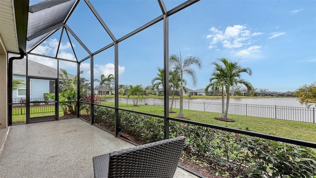 sunroom / solarium featuring a water view