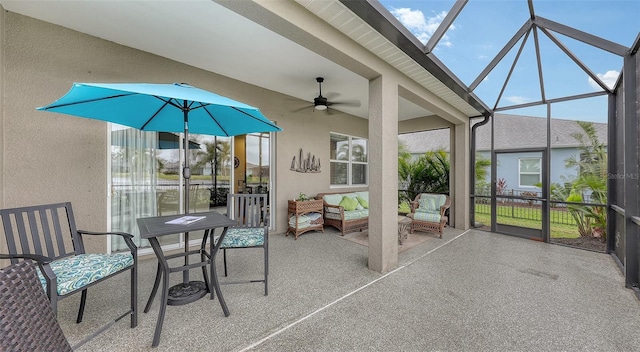 unfurnished sunroom with ceiling fan