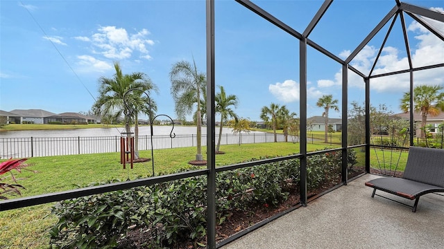 unfurnished sunroom featuring plenty of natural light and a water view