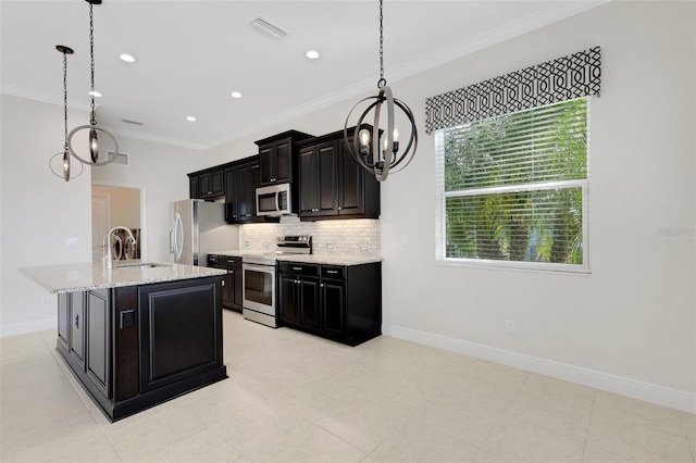 13789 Old Creek Ct, Parrish, FL 34219 - kitchen with stainless steel appliances, a chandelier, backsplash, dark cabinetry, and ornamental molding