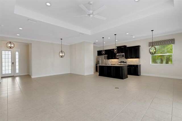 13789 Old Creek Ct, Parrish, FL 34219 - kitchen with open floor plan, stainless steel appliances, dark cabinets, light countertops, and healthy amount of natural light